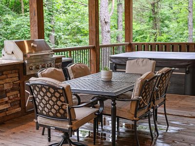 Outdoor dining table and gas grill.