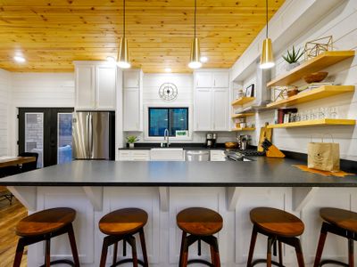 5 stools can be found at the bar top for additional seating.