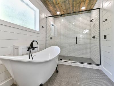 A private bathroom with a soaking tub and a walk-in shower with double heads.