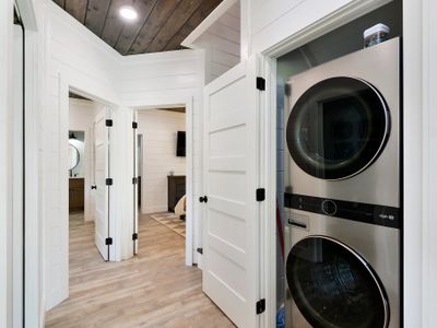 Off the kitchen is the laundry closet as well as both Master Suites!