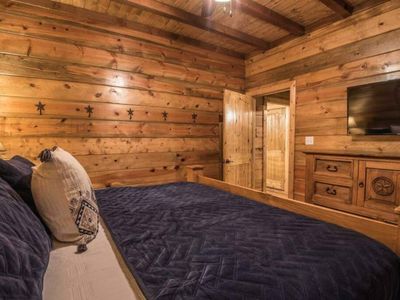 The third bedroom, featuring a king sized bed and smart tv.