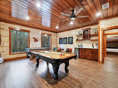 A pool table, air hockey and wet bar are a few of the amenities found downstairs