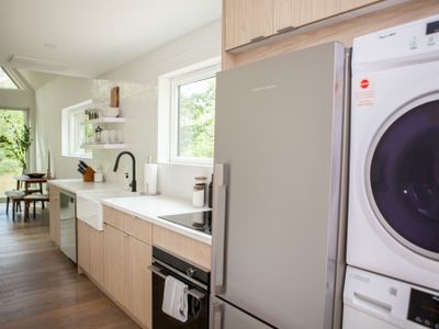 Kitchen interior with washer and dryer.