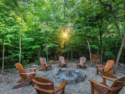 Large outdoor firepit and chairs surrounding.