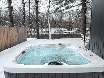 Enjoy the hot tub with river views, just steps off the back porch.