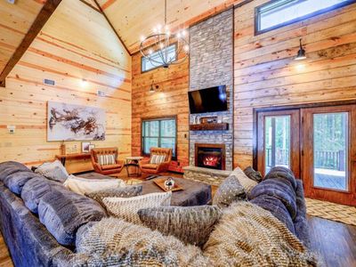 An oversized section sits around the electric fireplace and flat screen.