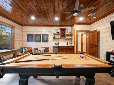 The pool table is at the heart of the game room.