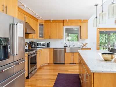 A spacious kitchen with stainless steel appliances awaits your culinary creativity.