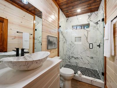 A walk-in shower is the heart of this full bathroom.