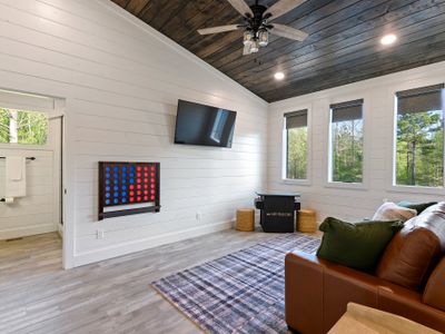 This room has an oversized Connect 4 game and arcade console.