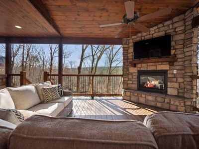 The outdoor covered patio with oversized outdoor sectional around the fireplace