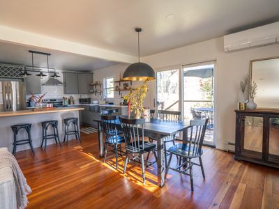 The open concept flows between the living room, dining area, and kitchen.