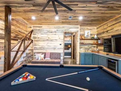 Pool table + A wet bar with a minifridge and smart tv!