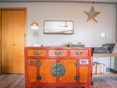 Living area includes a record player with vinyl collection and Marshall speaker.