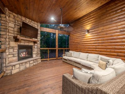 The outdoor covered patio with oversized outdoor sectional around the fireplace