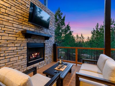 The gas fireplace and smart tv on the covered deck.