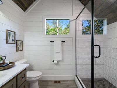 The full bathroom for the second floor to share featuring a walk-in shower.
