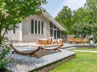 Step onto the back deck from the Three Seasons Room, conveniently located on the right side of the house, just behind the outdoor dinning table.