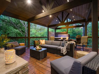 The outdoor covered patio has oversized outdoor sofas and extra lounging chairs.