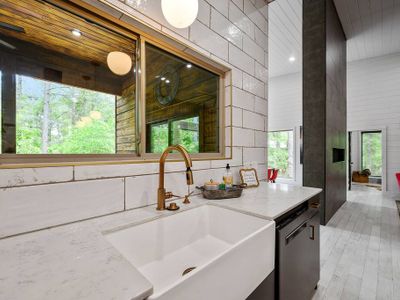 The sink is accompanied by a large window overlooking the patio.
