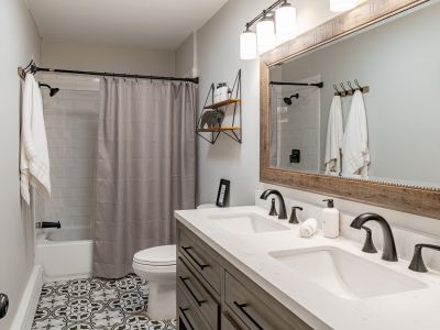 Full bathroom with tub and double sinks