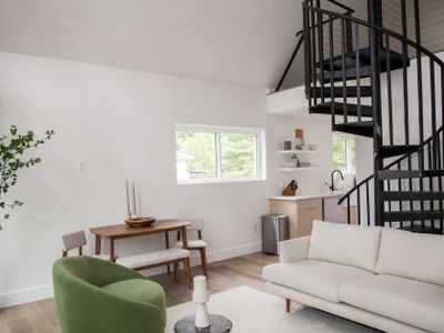 Living room seating area and spiral staircase.