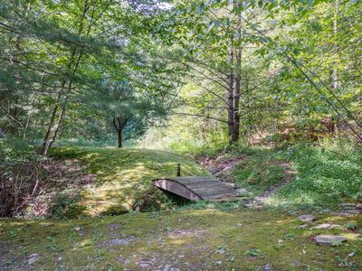 Over this miniature bridge lies a private pond, just steps away from the house.