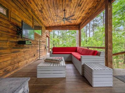 Outdoor sectionals are placed around a flat screen for ultimate entertainment.