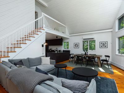 View of the kitchen, dining, and living area. Stairs lead to upstairs master bedroom