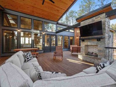 An oversized outdoor sectional placed around the fireplace and tv!