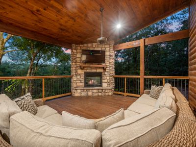 The outdoor covered patio with oversized outdoor sectional around the fireplace