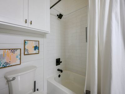 The private bath has a shower/tub combo.