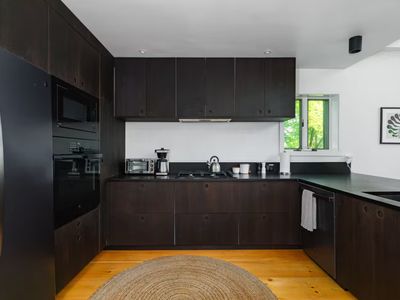 The kitchen area is open to the dining area, perfect for family gatherings! (Please know the dishwasher is currently unavailable)