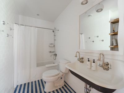 Full bathroom on the lower level in between bedrooms 2 & 3