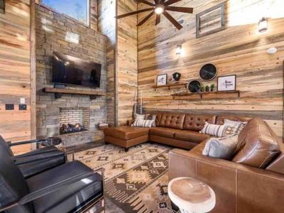 The living room features couches and chairs nestled around a fireplace!