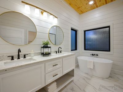 This private bathroom has a double vanity and a soaking tub.