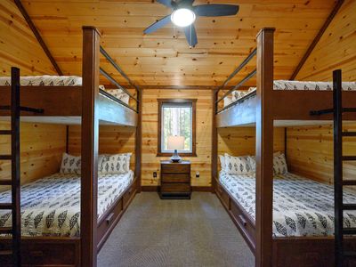 Off the loft is the bunk room featuring 4 Queen beds!