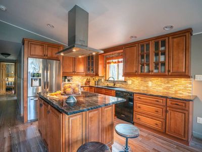 Chef's kitchen stocked with pots, pans and cooking basics.