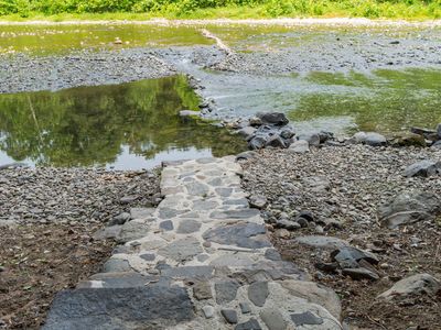 A private dock, made from natural stone pulled from the creek bed, allows you to enter the river. Particularly after heavy rains, this thoughtful addition makes for an easy access point.