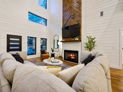 The heart of the living room is a gas fireplace and a smart TV.