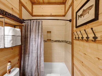 A shower/tub combo in the shared bathroom.