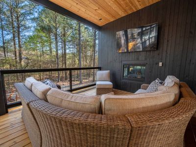 Oversized outdoor couch around the fireplace!