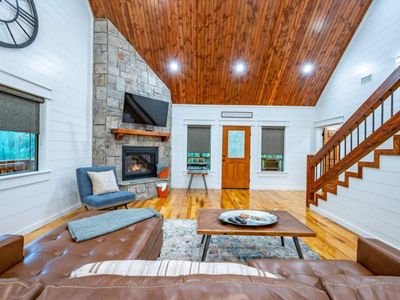 The living area features a leather sectional and an indoor fireplace!