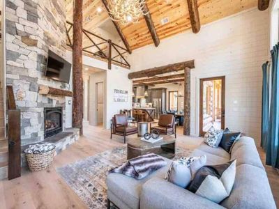 The living room has a gas fireplace, oversized sectional and chairs for lounging!