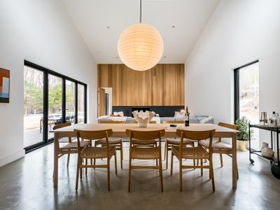 Spacious dining area perfect for gathering and sharing meals with beautiful forest views.