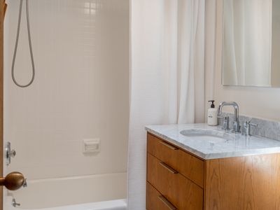 The skylight allows the sun and stars to shine in this newly renovated bathroom.