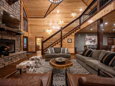 Floor to ceiling fireplace, love seat & oversized couch add comfort to the room