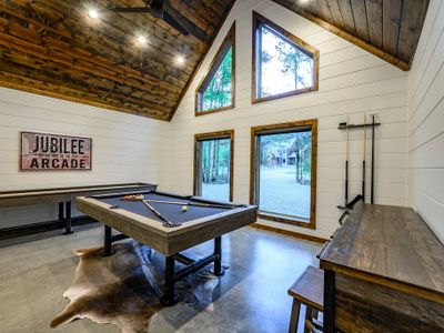 The game room is equipped with a pool table and shuffleboard.