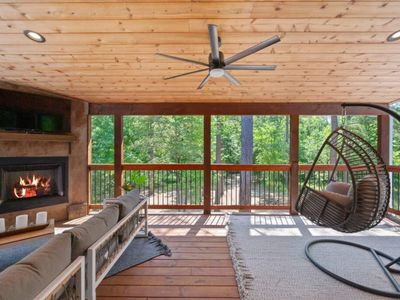 The private covered balcony has luxury seating and a fireplace.