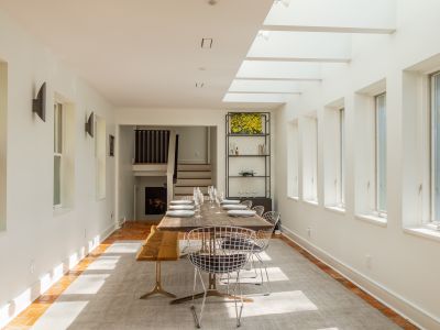 Looking from the kitchen into the spectacular dining room, with wall-to-wall windows and skylights.